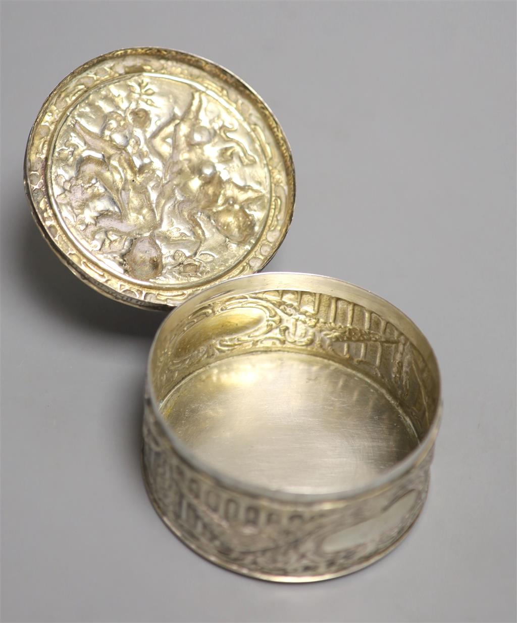 A late 19th/early 20th century German embossed 800 white metal circular box, with hinged cover, 9.5cm, 6oz.